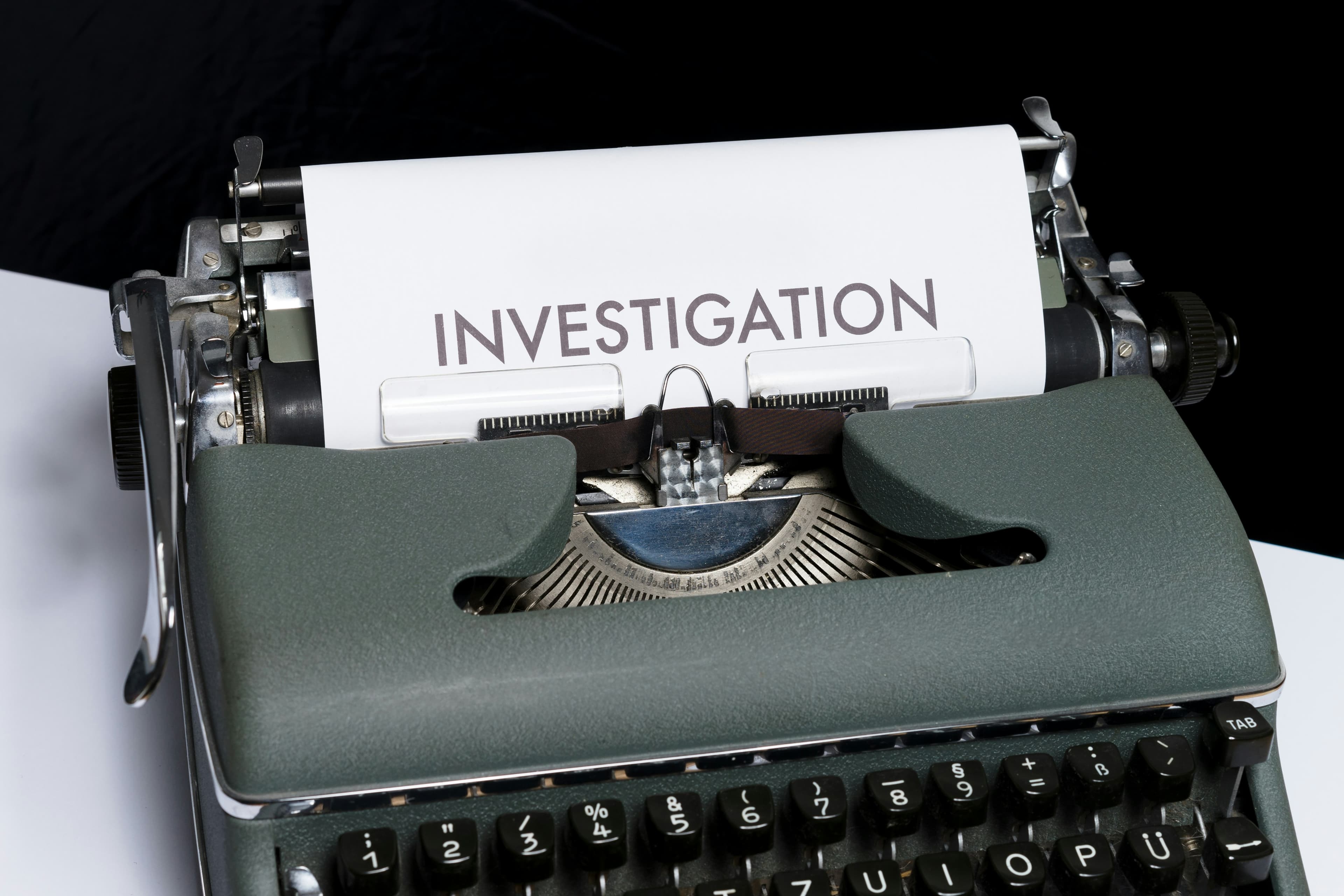 Vintage typewriter with the word Investigation — private detective services